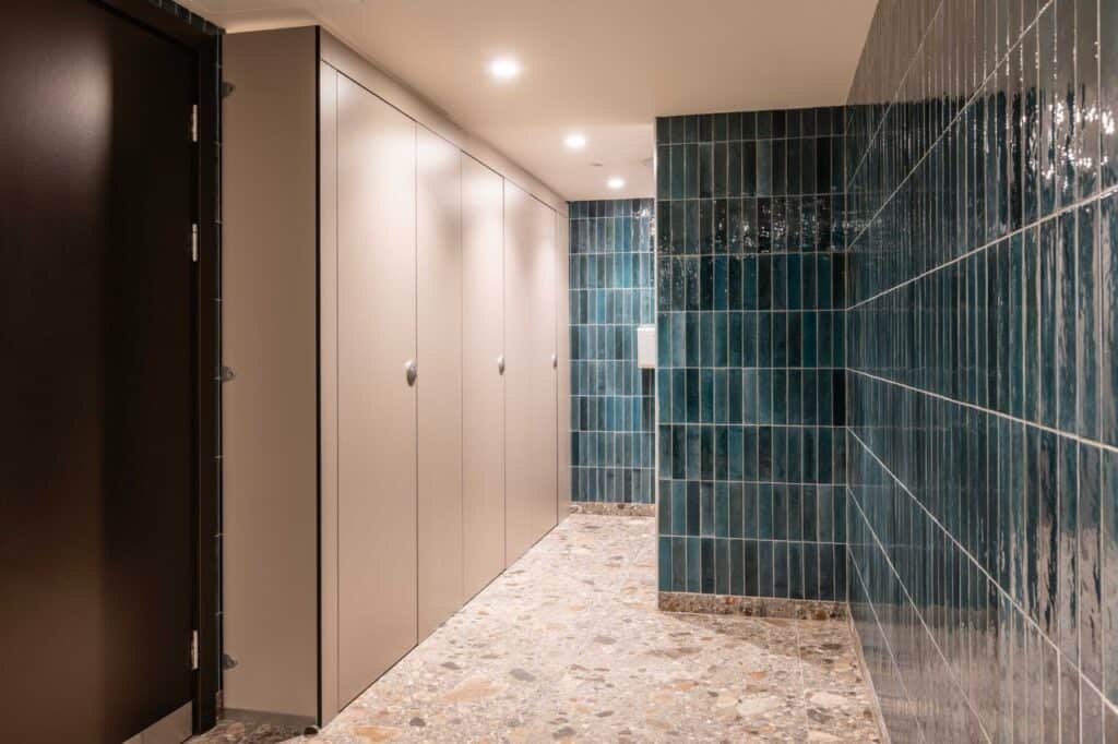 Row of Identity Shower cubicles in gym changing room